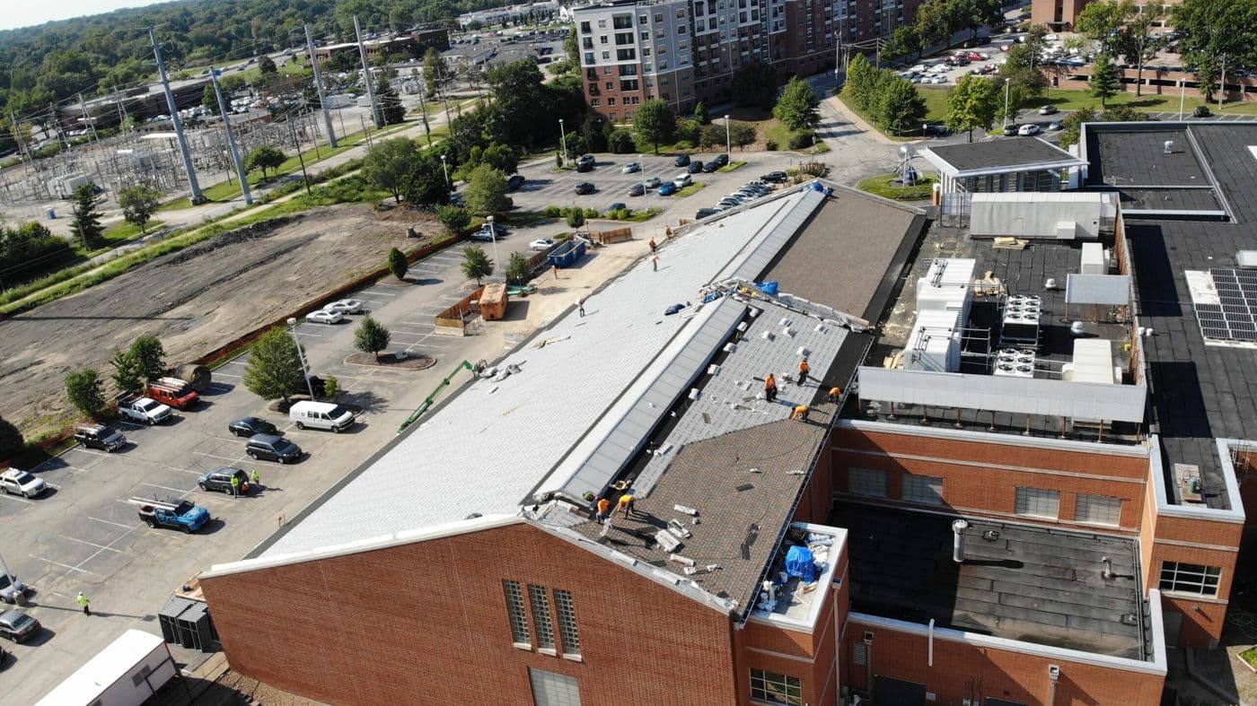 Aerial view of Revolve Construction crews re-roofing a commercial building in St. Louis
