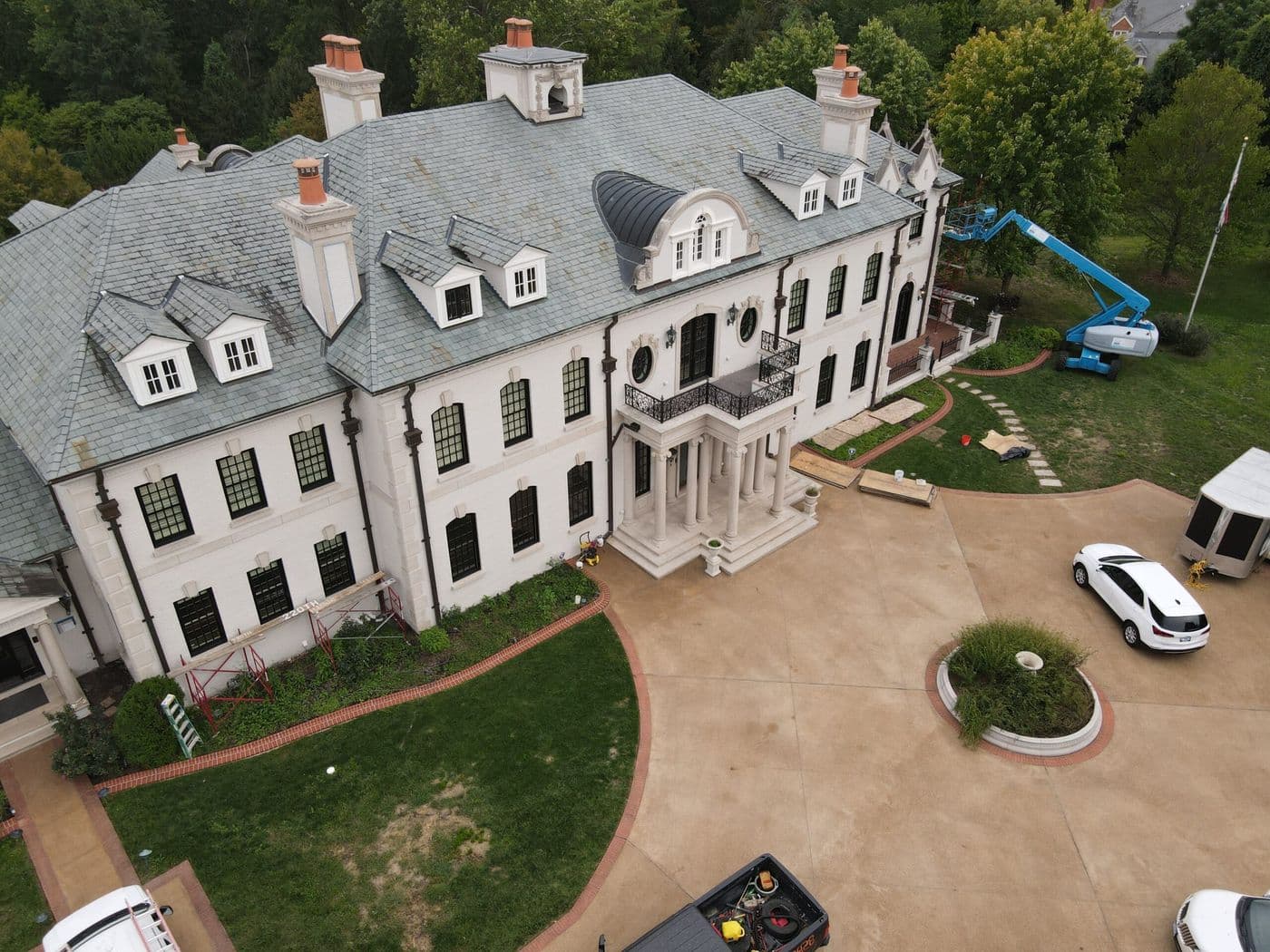 Aerial view of a large estate roof replacement in progress