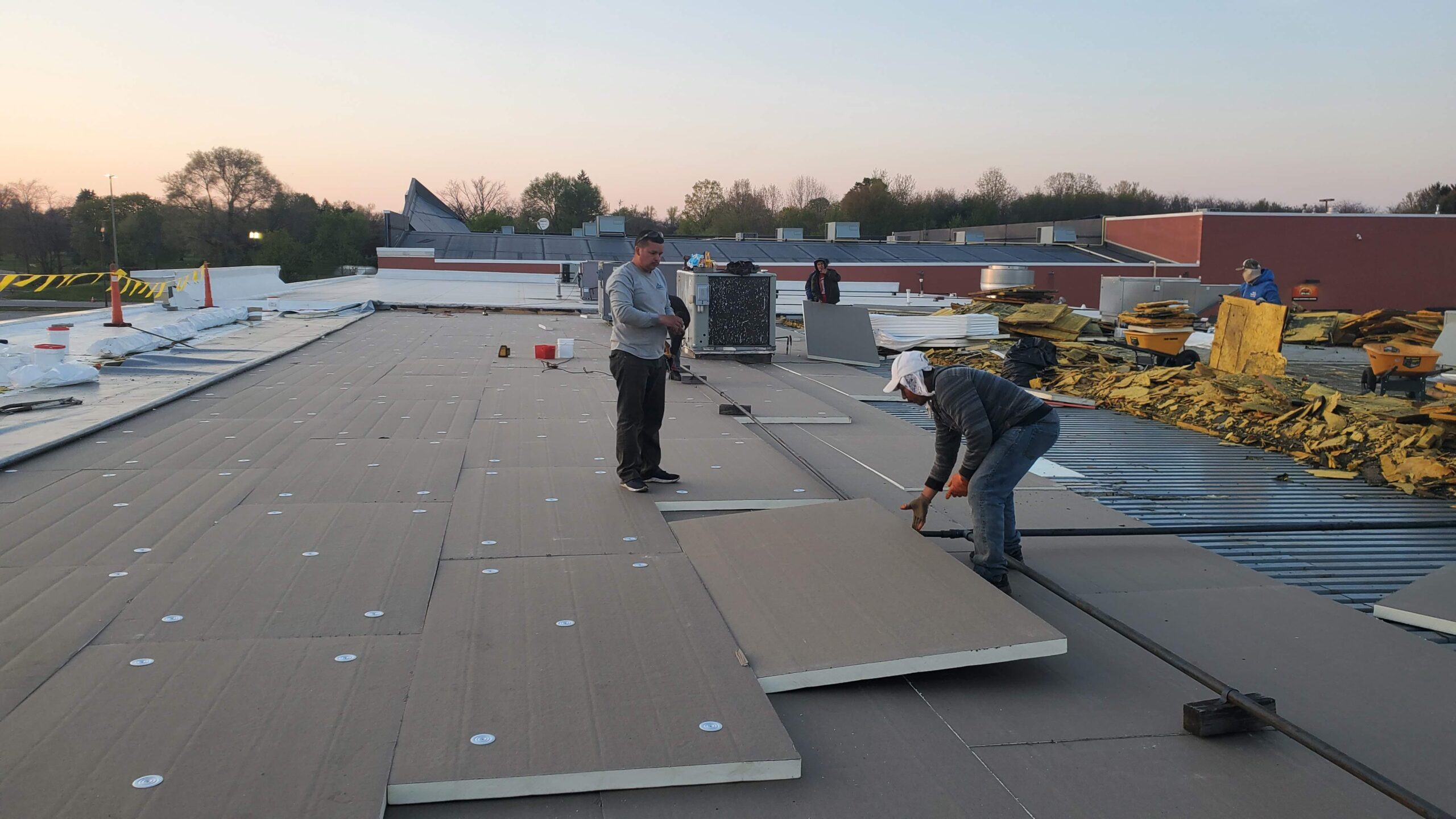 Modern residential construction site at sunset with completed framing