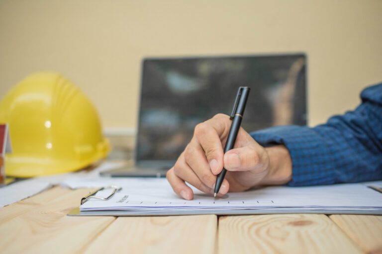 Hand hold pen writing on document