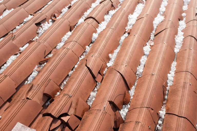 Construction workers installing roofing tiles on a new build.