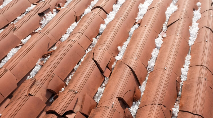 Construction workers installing roofing tiles on a new build.